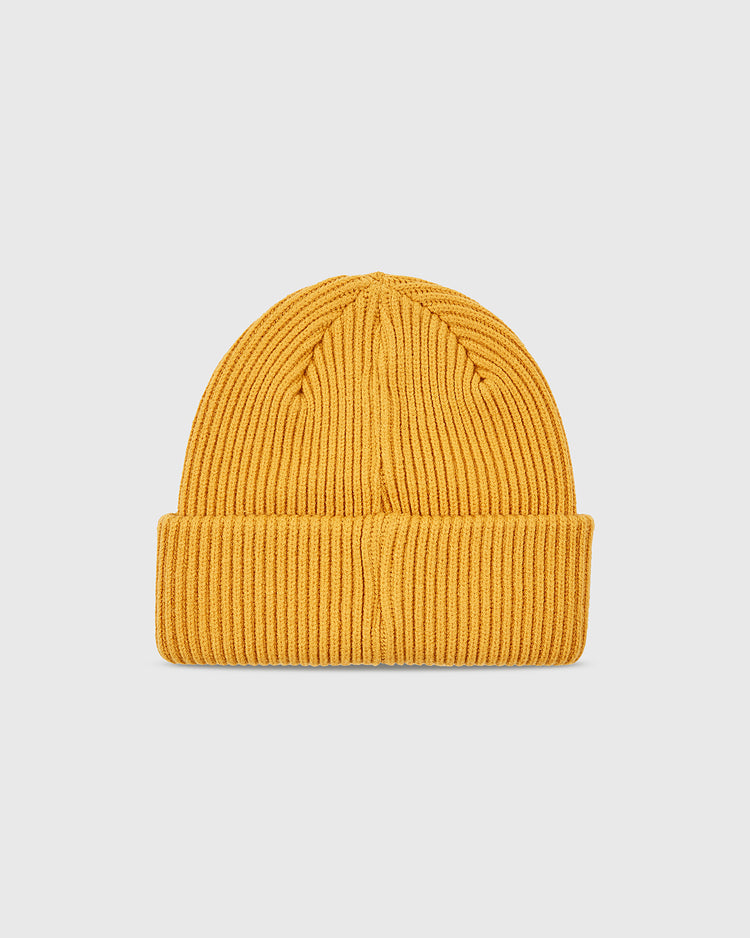 The Ebbets Field Salt Lake Bees Patch Logo Ribbed Beanie in mustard yellow features a folded brim and is shown on a light gray background.