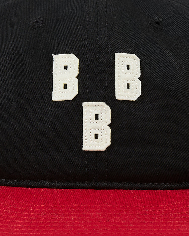 The Ebbets Field Birmingham Black Barons 1948 Cotton Twill Ballcap is a black and red cap with three white embroidered Bs in a triangle, inspired by the classic Negro Leagues style worn by the legendary team and Willie Mays.