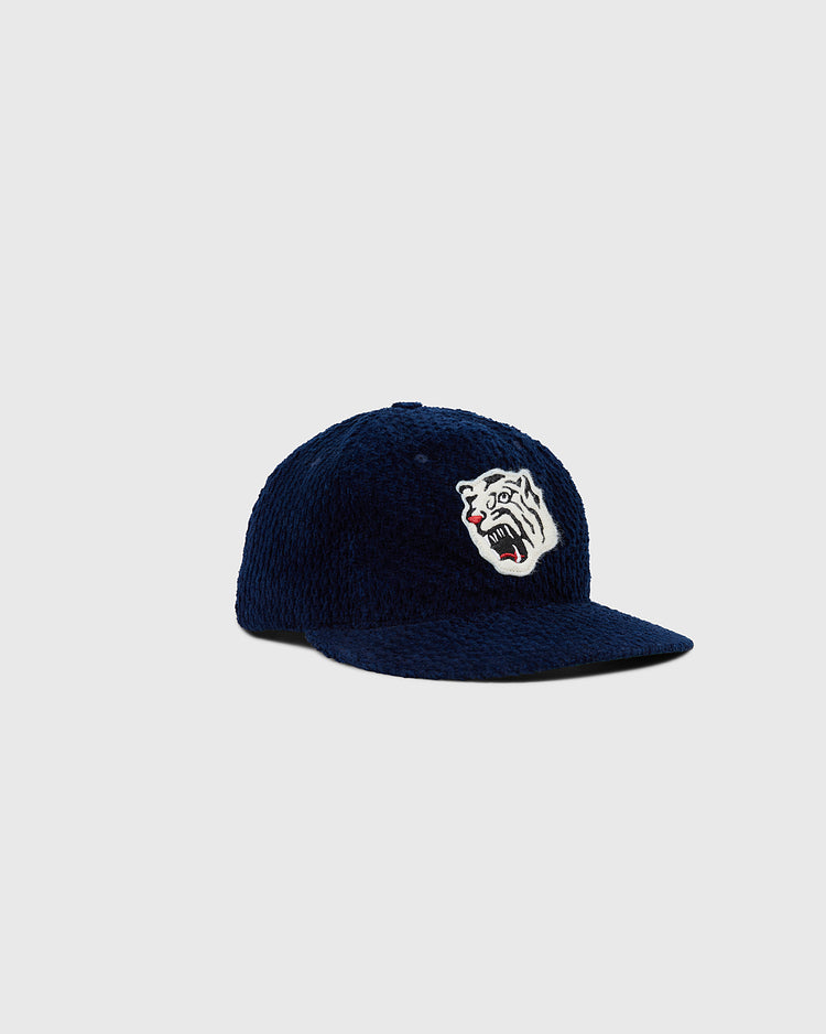 The Ebbets Field Osaka Tigers Japanese Indigo Corduroy Ballcap features navy blue indigo-dyed corduroy and a snarling white tiger embroidered patch, shown against a plain light gray background.