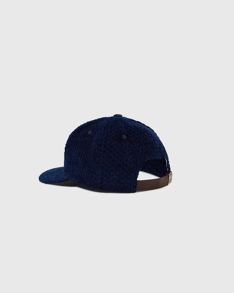 The Ebbets Field Tokyo Giants Japanese Indigo Corduroy Ballcap is shown from the back in navy blue, featuring a brown adjustable strap and buckle against a plain light gray background.