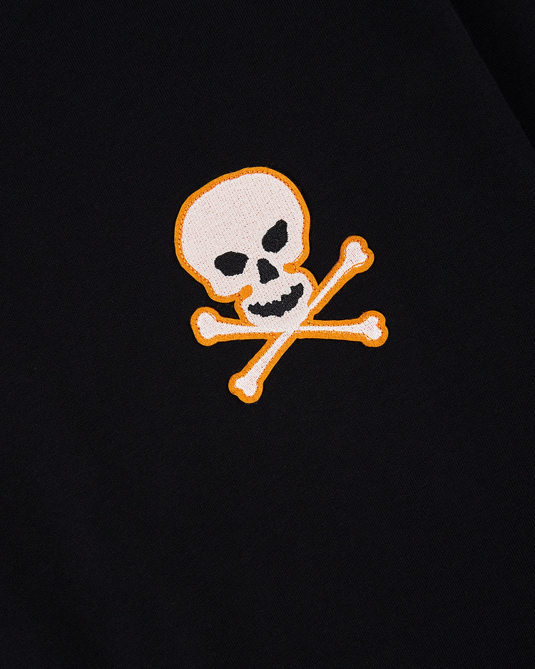 The Ebbets Field Sioux City Ghosts 'Skull and Bones' Short Sleeve Tee Shirt features a white skull and crossbones with a yellow outline on black, inspired by vintage souvenir tees from the legendary fast-pitch team.