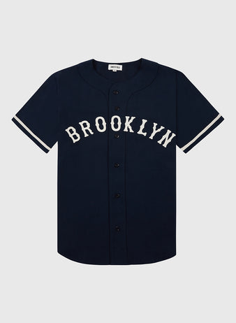 The Ebbets Field Brooklyn Eagles Cotton Twill Baseball Jersey is a navy short-sleeve top with white sleeve stripes, bold BROOKLYN lettering, and black front buttons, inspired by the Negro Leagues’ Brooklyn Eagles.