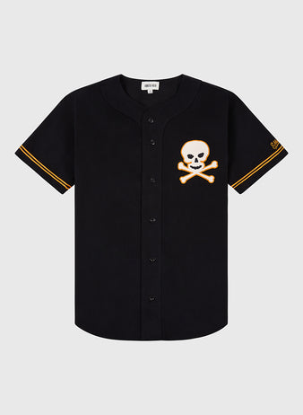 The Sioux City Ghosts Cotton Twill Baseball Jersey by Ebbets Field is a black short-sleeve jersey with orange sleeve trim and a skull-and-crossbones patch—perfect for fans and fast-pitch softball enthusiasts.