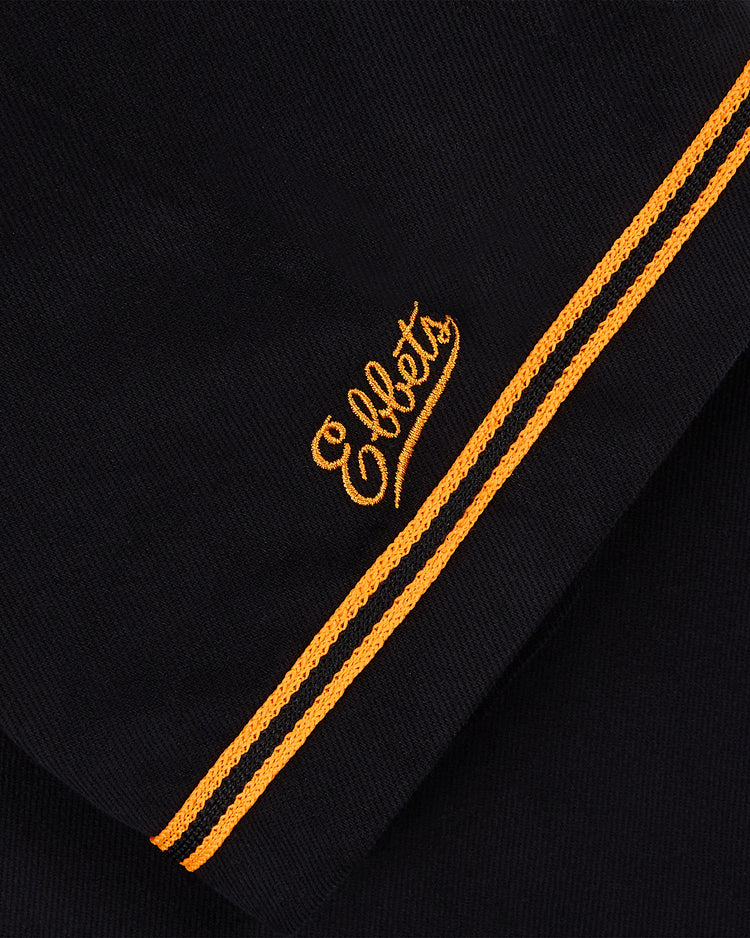 Close-up of black cotton twill fabric with two yellow stripes and 