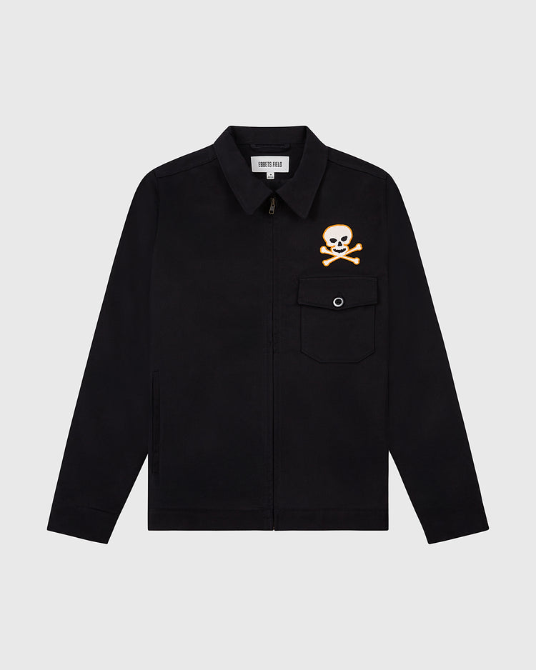 The Ebbets Field Sioux City Ghosts Cotton Grounds Crew Jacket is a black fast-pitch softball jacket with a front zipper, collar, and chest pocket. An orange and white skull and crossbones graphic appears above the left pocket on a plain white background.