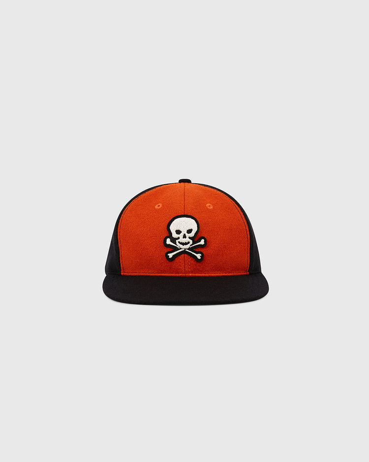 The EFF Sioux City Ghosts 1935 Authentic Wool Softbrim Ballcap features an orange front panel, black sides and brim, and a white skull and crossbones emblem.