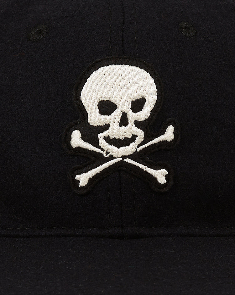 A close-up of the Ebbets Field Sioux City Ghosts Vintage Inspired Wool Ballcap, featuring a white embroidered skull and crossbones on the front.