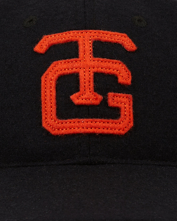 The Tokyo Giants 1952 Authentic Wool Ballcap by Ebbets Field features a black wool crown and a bold orange interlocking T and G logo embroidered on the front, inspired by the classic 1952 Tokyo Giants style.