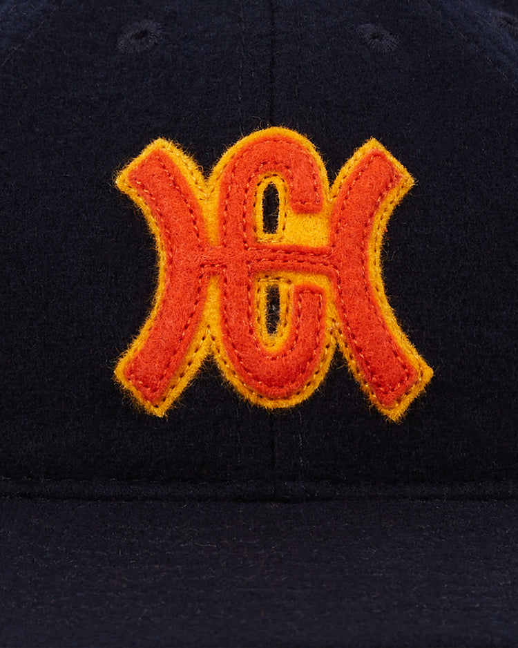 The Ebbets Field Hiroshima Carp 1959 Authentic 8-Panel Wool Ballcap features a navy crown with a red and yellow embroidered interlocking KC logo, inspired by the classic 1959 team style.
