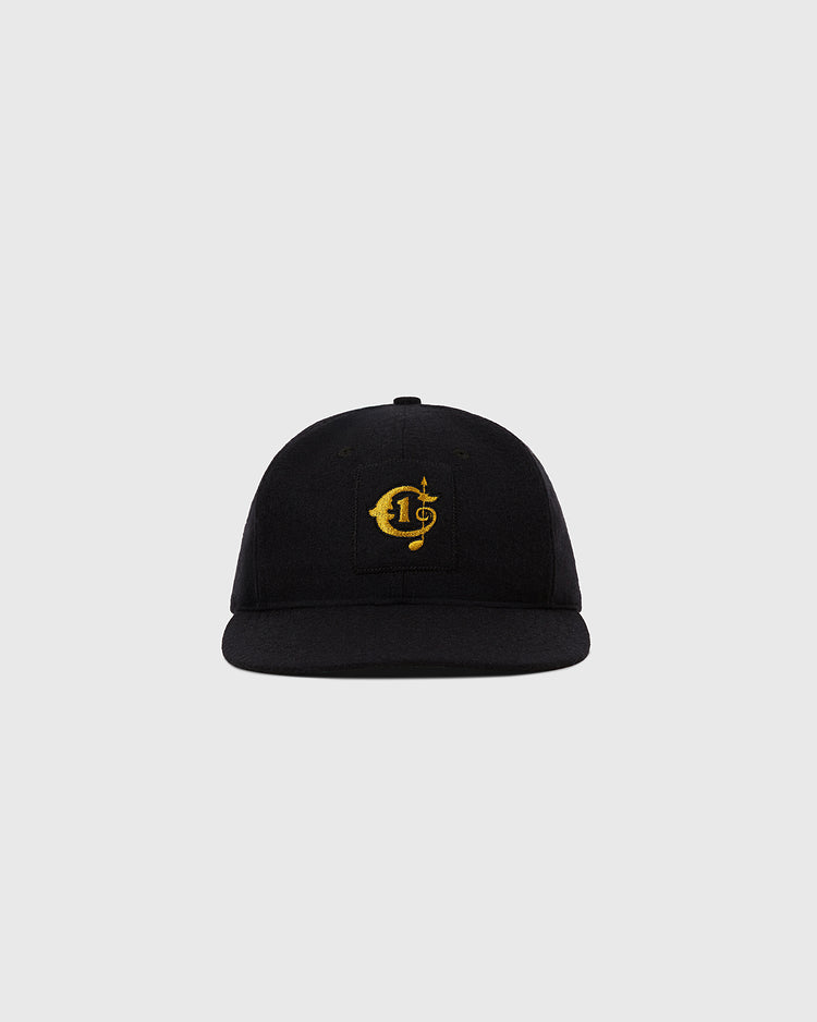 The Ebbets Field Tokyo Giants 1951 Authentic Wool Ballcap is black with a gold embroidered C and dollar sign logo, inspired by the original cap, shown on a plain light grey background.