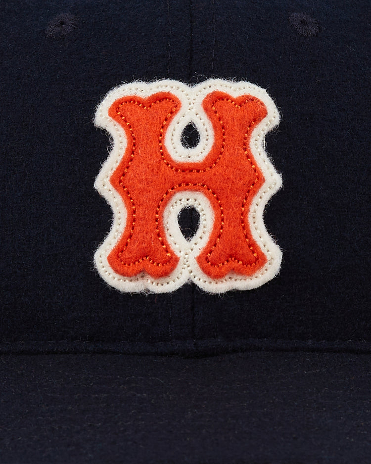 A close-up of the Ebbets Field Hiroshima Carp 1958 Authentic Wool Ballcap in navy, featuring an orange H with a white outline sewn on the front—a tribute to the classic 1958 design.