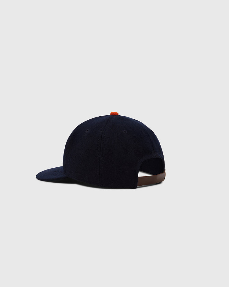 The Ebbets Field Hiroshima Carp 1958 Authentic Wool Ballcap is shown from the back, featuring navy wool, a curved brim, adjustable brown strap, and a small orange top button against a plain light gray background.