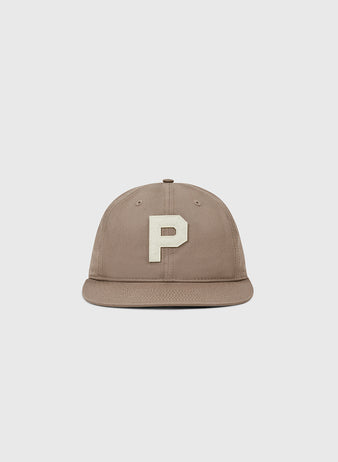 The Paris Red Peppers Cotton Twill Ballcap by Ebbets Field is a taupe baseball cap with a flat brim and a large, white letter P embroidered on the front, shown against a plain light grey background.