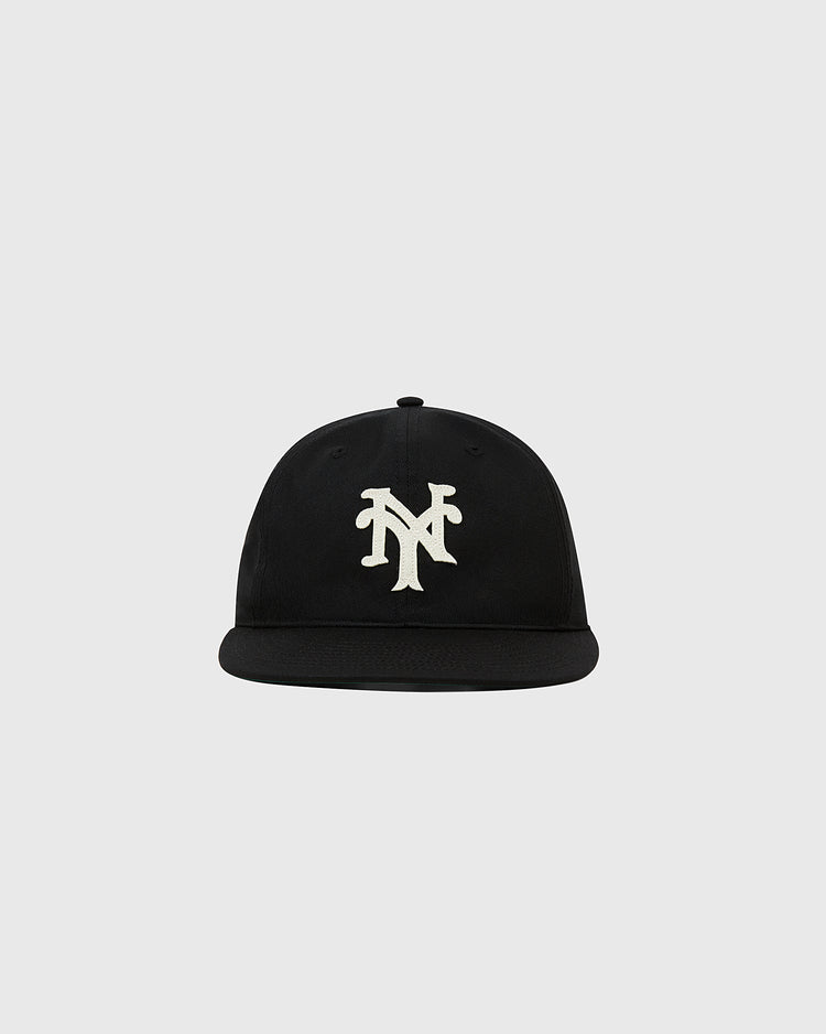The Ebbets Field New York Cubans Cotton Twill Ballcap is a black flat-brim cap with a white NY logo, inspired by the legendary Negro League team, shown on a plain light gray background.