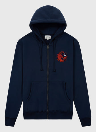 The Ebbets Field Hiroshima Carp Heavyweight Cotton Terry Full-Zip Hoodie is a navy vintage-style hoodie with front pockets and a hood, featuring a red and black embroidered yin-yang patch with abstract elements on the left chest.