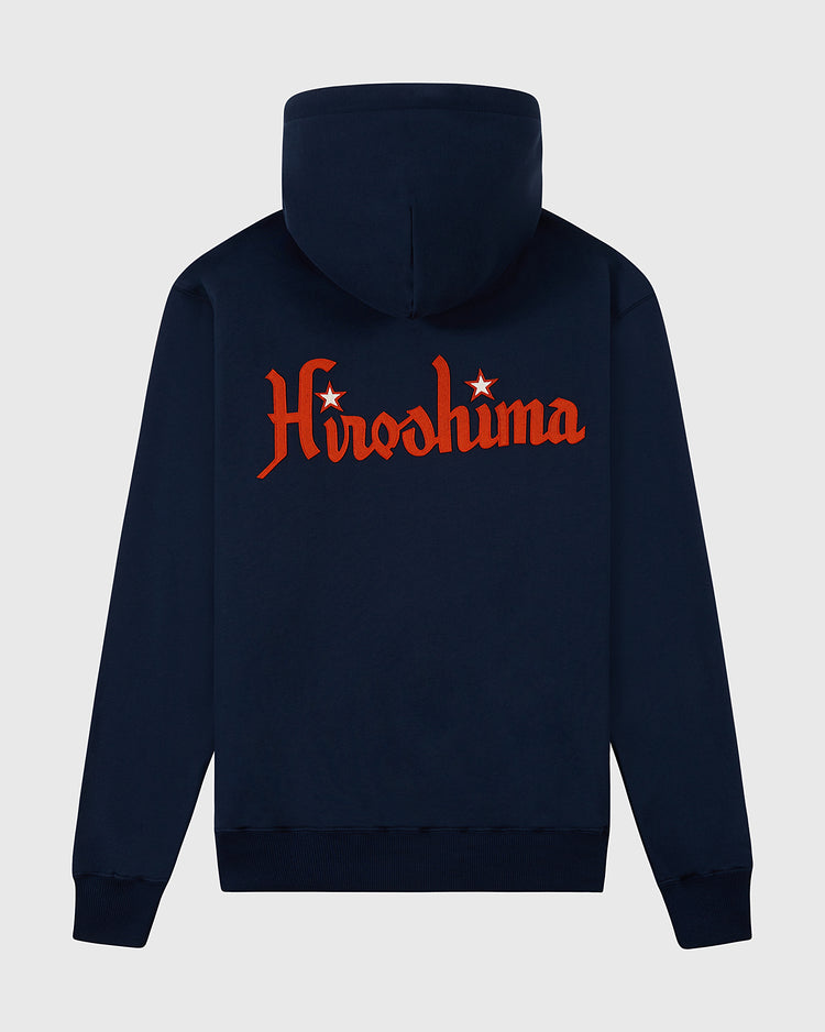 The Ebbets Field Hiroshima Carp Heavyweight Cotton Terry Full-Zip Hoodie in navy blue features “Hiroshima” in bold red vintage-style letters with stars above the i and o on the back for a retro look.