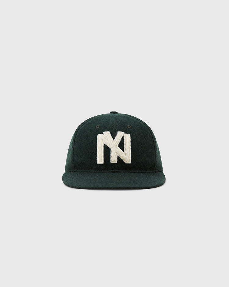 The Brooklyn Eagles 1935 Wool Ballcap by Ebbets Field is a dark green cap with a large white embroidered NY logo, inspired by the historic Negro Leagues, shown against a plain light gray background.