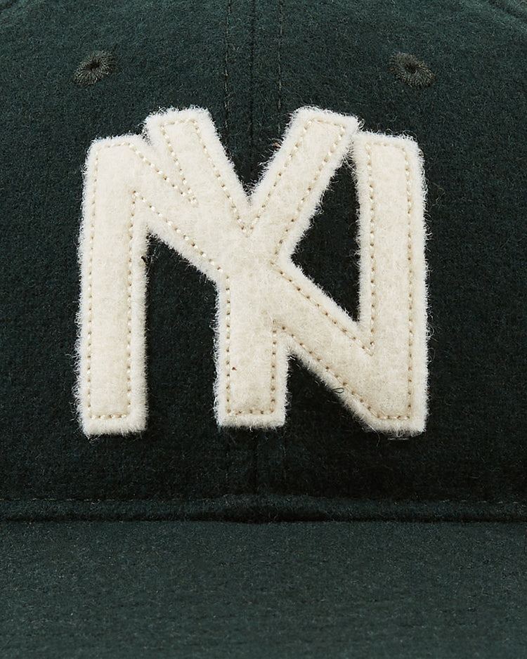 Close-up of the Ebbets Field Brooklyn Eagles 1935 Wool Ballcap in dark green, featuring a large white felt NY logo on the front, inspired by the vintage style of classic Negro Leagues teams.