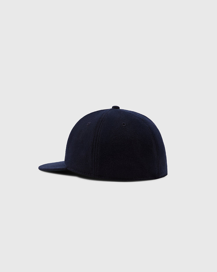 The Ebbets Field Aloha 100th Infantry 1942 Authentic Ballcap Navy, shown from the back and side against a light gray background, features a flat brim and crown stitching, honoring Japanese-American history with vintage style.