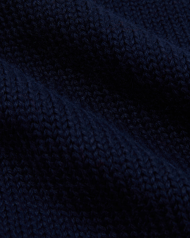 Close-up of dark navy blue knitted fabric from the EFF Boston Red Sox 1924-1960 Wool Shawl Collar Sweater, highlighting textured diagonal ridges and rows of tightly woven yarn.