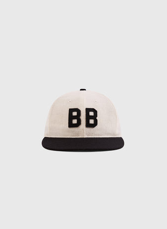 The Ebbets Field Babe Ruth Bustin' Babes Authentic Wool Ballcap features a white crown, black brim, and bold front 