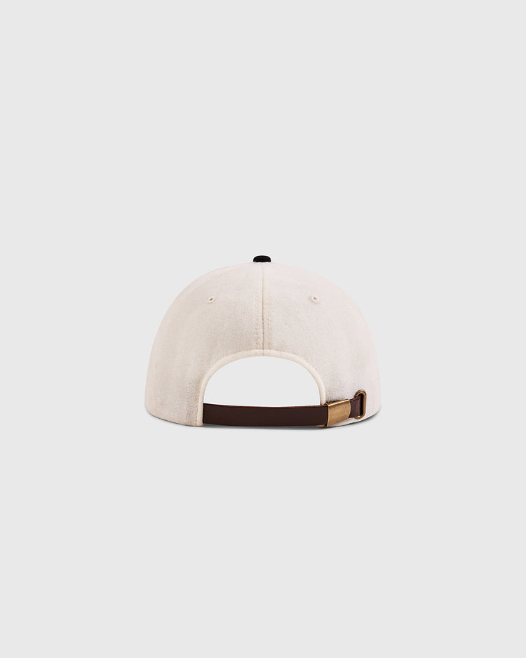 The Ebbets Field Babe Ruth Bustin' Babes Authentic Wool Ballcap is shown from the back, with a beige wool finish, adjustable brown strap, and brass clasp. This classic cap design honors the iconic 1927 Yankees. Set against a plain, light background.