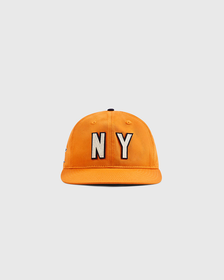 An orange Ebbets Field New York 1939 World's Fair cotton twill ballcap with bold black and white NY embroidery displayed on a plain, light gray background.