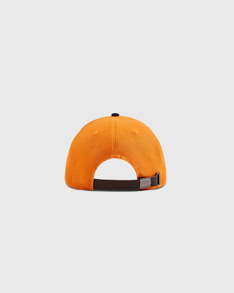 A bright orange Ebbets Field New York 1939 World's Fair Cotton Twill Ballcap viewed from the back, with an adjustable brown strap and small metal clasp, set against a plain light gray background.