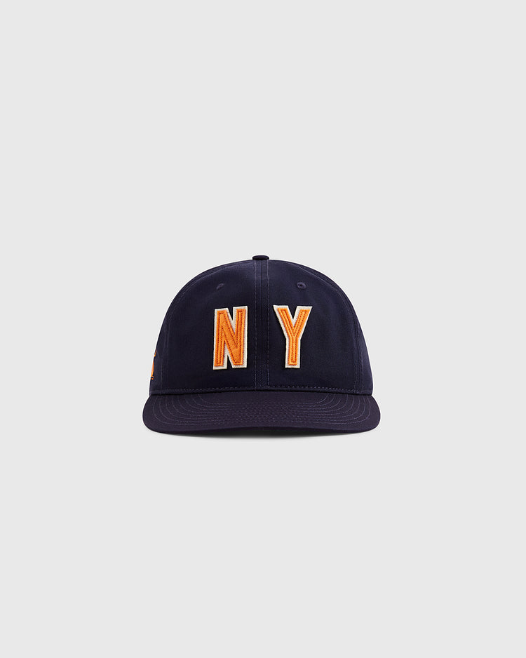 The Ebbets Field New York 1939 World's Fair Cotton Twill Ballcap features large orange and white “NY” embroidery on navy blue, inspired by Babe Ruth’s era, shown against a plain light gray background.