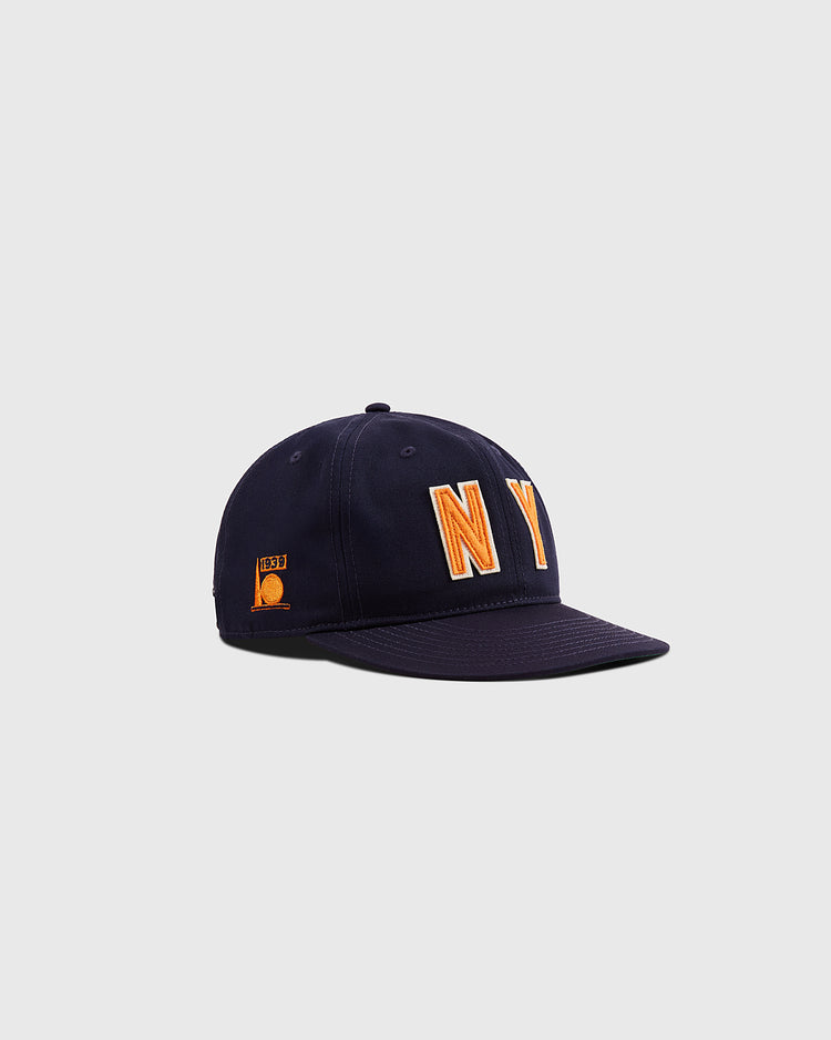 The Ebbets Field New York 1939 World's Fair Cotton Twill Ballcap features bold orange and white NY lettering on navy blue, with a small orange patch on the side, shown against a plain gray background—a vintage-inspired classic.
