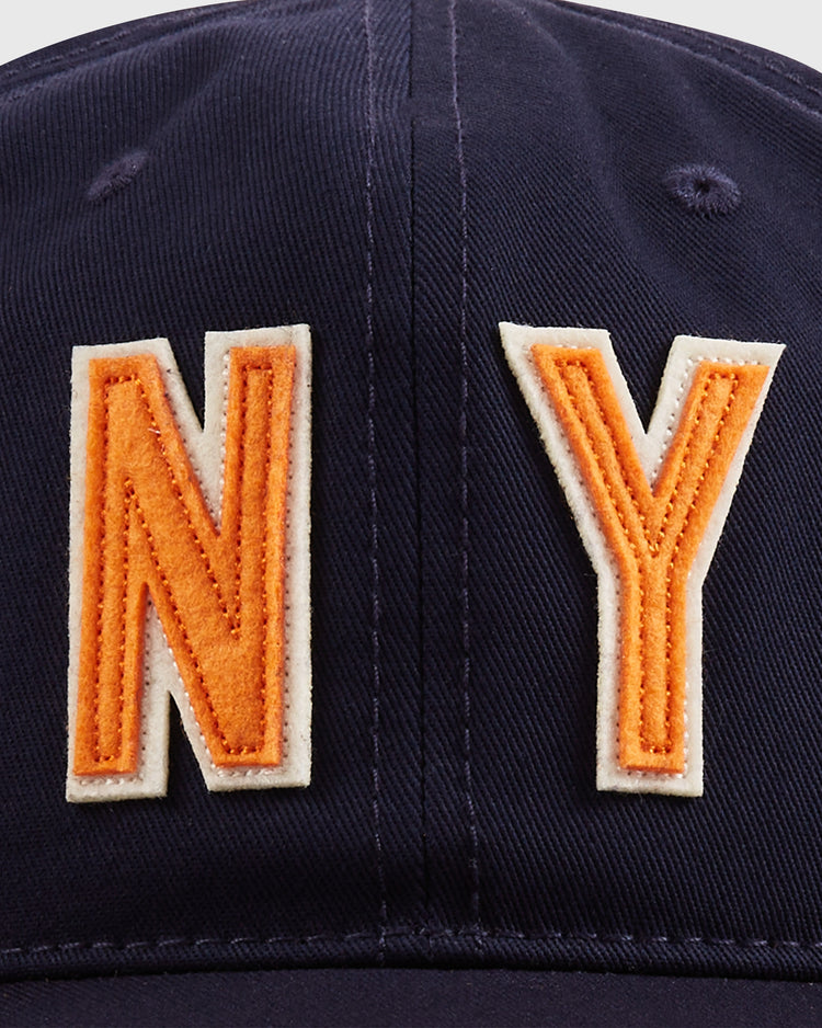 Close-up of the Ebbets Field New York 1939 World's Fair Cotton Twill Ballcap, featuring bold orange and white NY embroidery on navy blue—a classic design inspired by baseball’s golden age.
