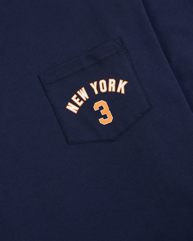 The Ebbets Field New York 1939 World's Fair Long Sleeve Graphic Tee features navy blue fabric, a chest pocket with orange NEW YORK text above the number 3, honoring Babe Ruth and the 1939 World’s Fair.