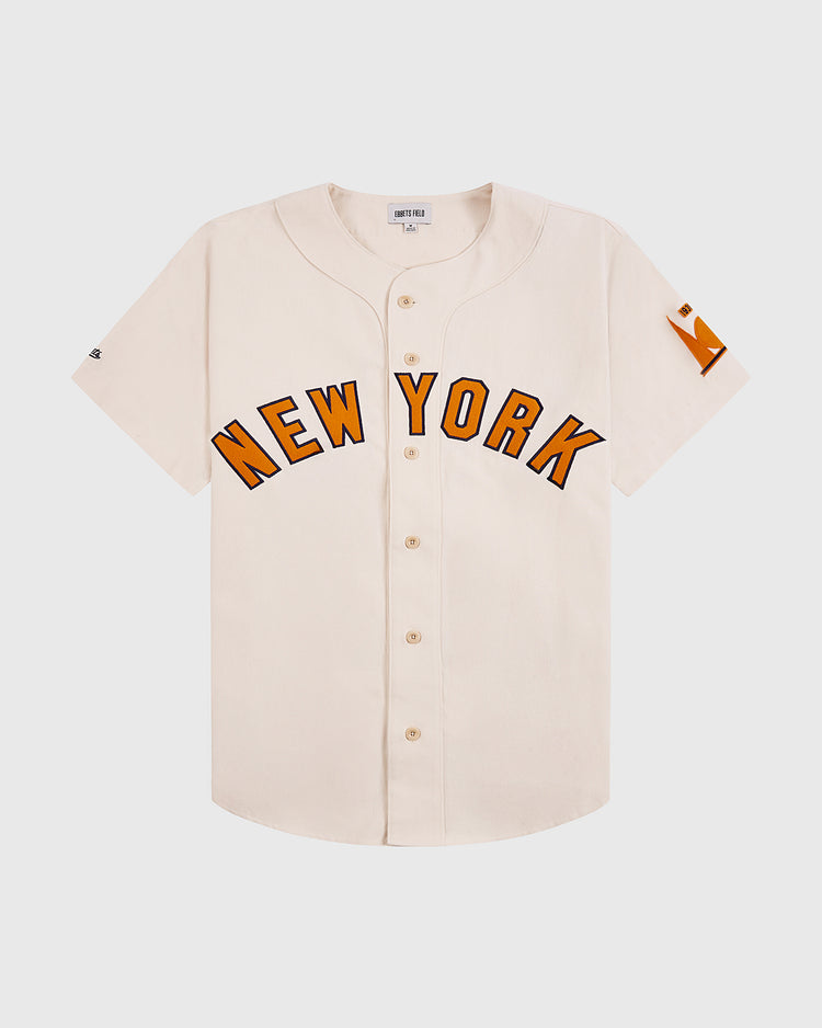 The Ebbets Field New York 1939 World's Fair Cotton Baseball Jersey is a white jersey with orange lettering inspired by classic Babe Ruth-era style.