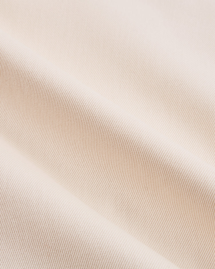 Close-up of soft, cream-colored cotton twill from the 1939 WORLD'S FAIR COTTON TWILL JERSEY by Ebbets Field, showing fine ribbed texture and gentle diagonal folds.