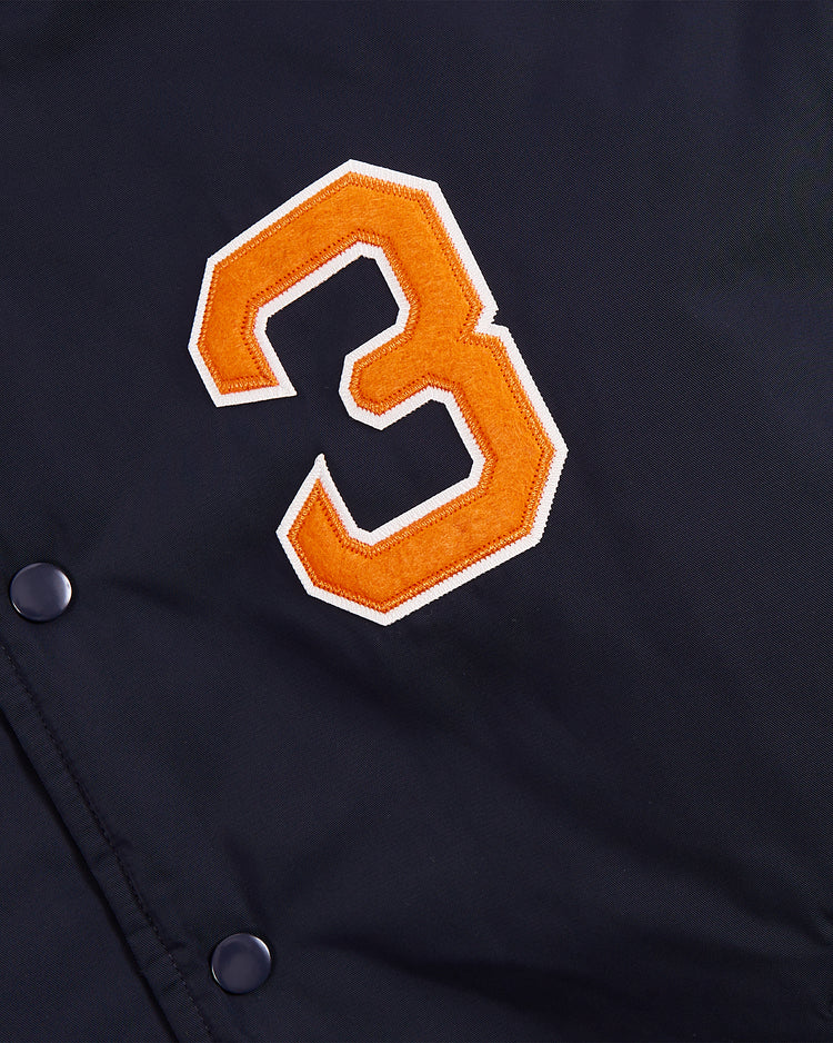 A close-up of the Ebbets Field New York 1939 World's Fair Satin Varsity Jacket, showcasing a large orange and white embroidered number 3 patch and visible snap buttons.
