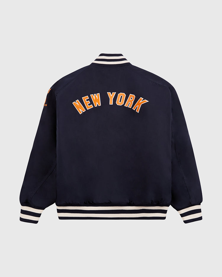 The Ebbets Field New York 1939 World's Fair Satin Varsity Jacket features white and orange NEW YORK lettering on the back, white-striped ribbed cuffs, collar, and waistband, shown against a light gray background.