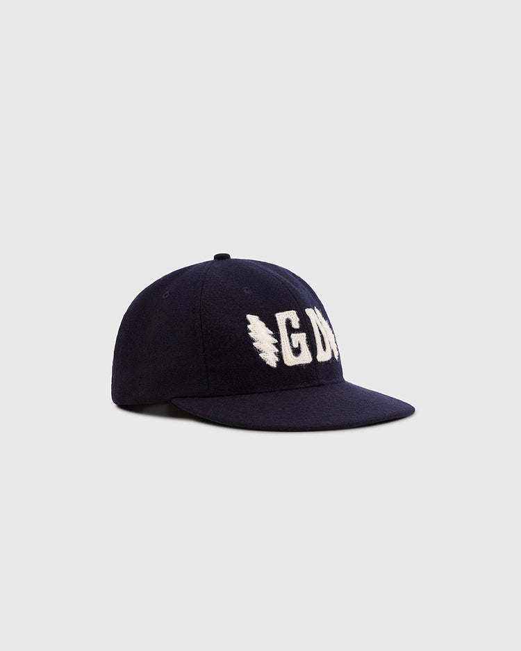 The Ebbets Field Grateful Dead Double Bolt Wool Ballcap in navy features bold white “GDN” embroidery on the front and is crafted from wool broadcloth, shown against a plain light gray background.