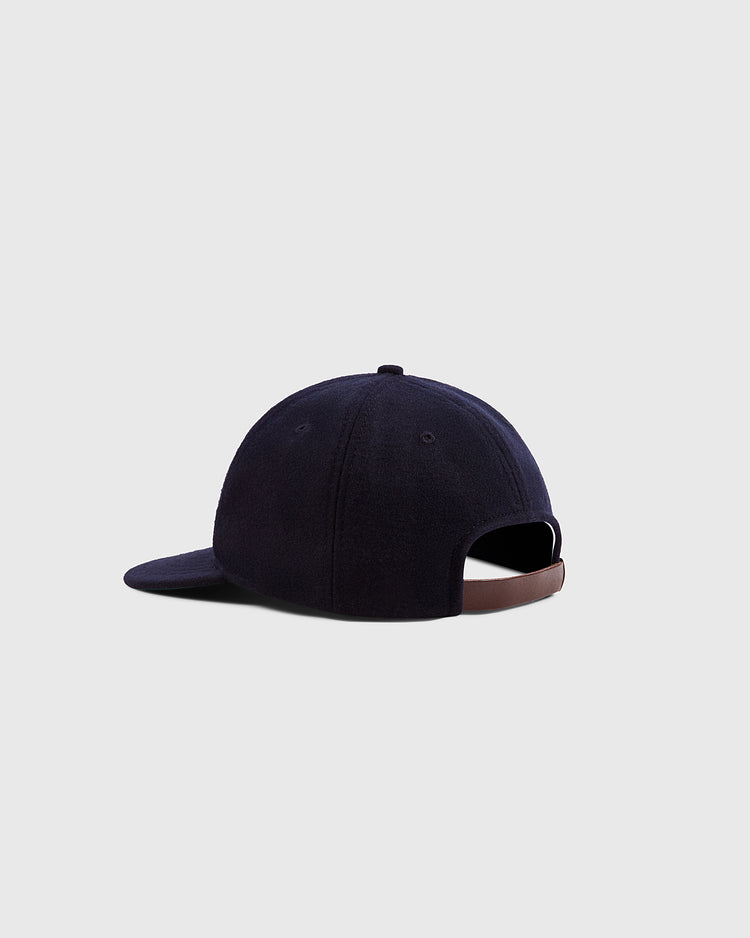 The Ebbets Field Grateful Dead Double Bolt Wool Ballcap is shown from the back, highlighting its navy wool broadcloth, brown adjustable strap, and curved brim against a plain light gray background.