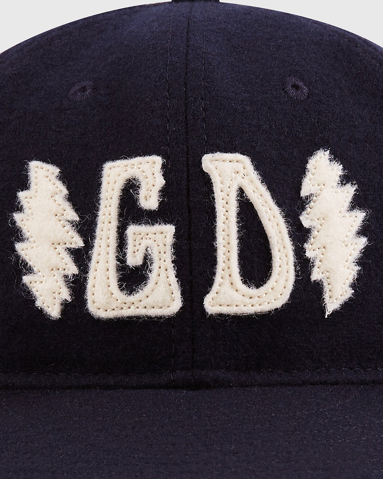 The Grateful Dead Double Bolt Wool Ballcap by Ebbets Field is a dark cap in wool broadcloth, featuring cream-stitched 