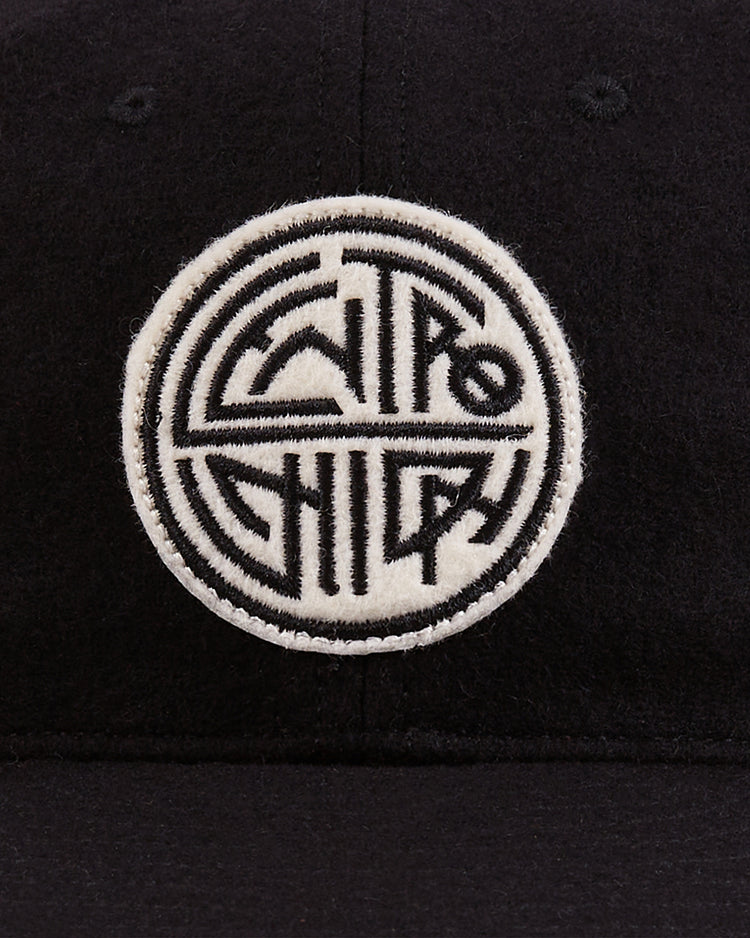Ebbets Field's Mystery Caps of Mexico – Centro Union Authentic Wool Ballcap is a black cap with a round embroidered patch, featuring Centro Chido in bold black geometric lines on a white background.