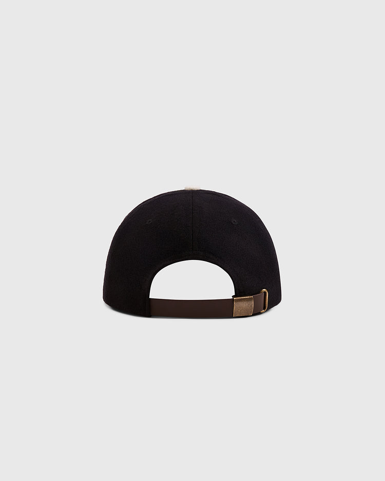 A rear view of the Ebbets Field Mystery Caps of Mexico – Centro Union Authentic Wool Ballcap in black, featuring a brown adjustable strap with a brass buckle, subtly celebrating Mexican baseball history against a light gray background.