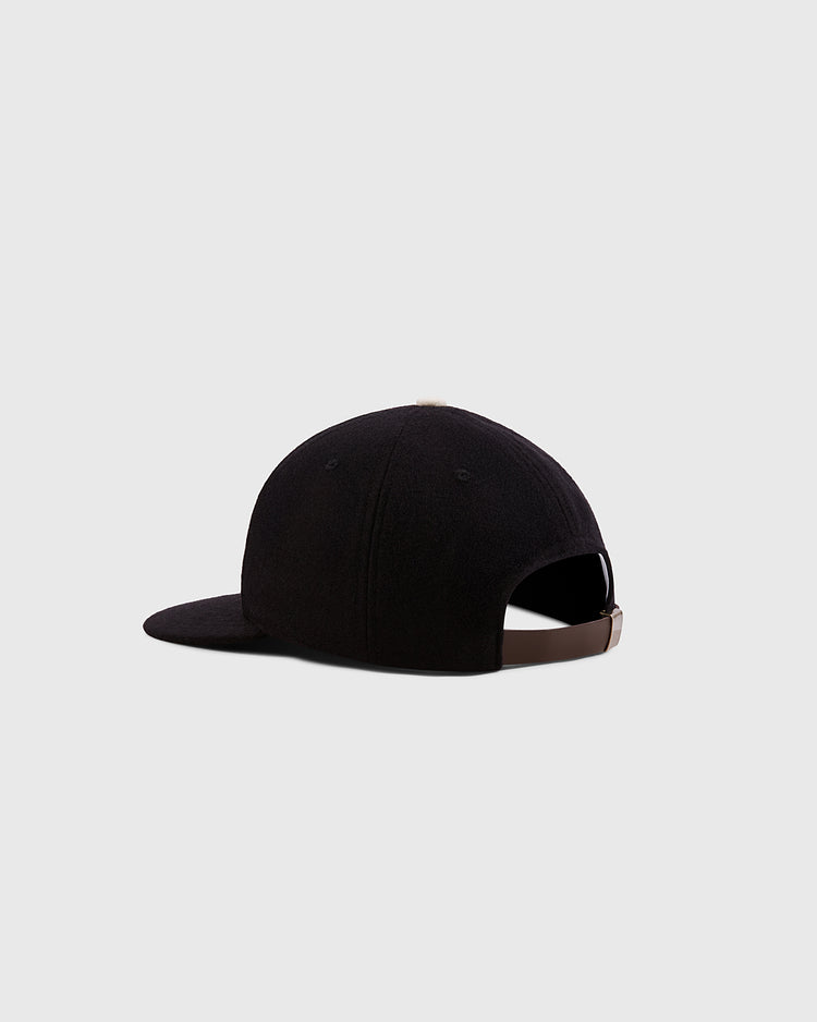 A black Ebbets Field Mystery Caps of Mexico – Centro Union Authentic Wool Ballcap viewed from the back and side, featuring an adjustable brown strap and buckle, set against a light gray background.