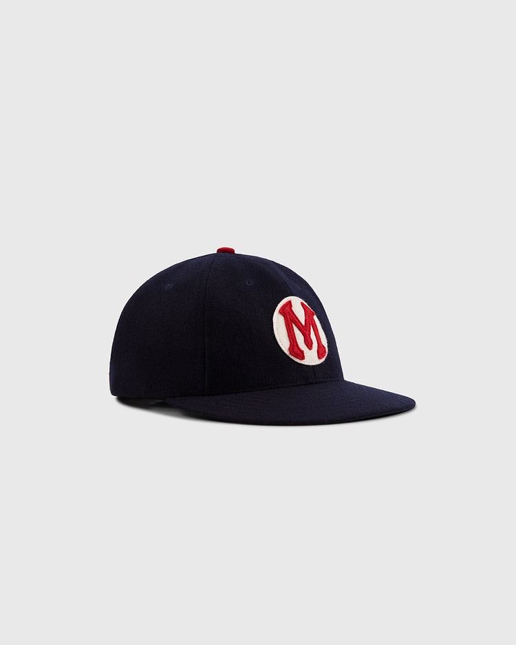 The Ebbets Field Mystery Caps of Mexico – Carta Blanca 1939 Authentic Wool Ballcap features a navy design with a red and white “M” on the front, celebrating Mexican baseball history, shown on a plain light gray background.