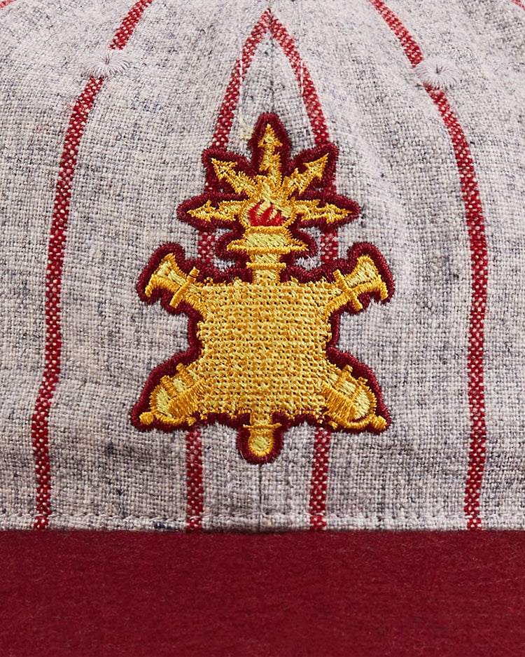 A close-up of the Ebbets Field Mystery Caps of Mexico – Heroico Colegio Militar Authentic Wool Ballcap: gray wool with red pinstripes, a gold and red flame emblem, and a solid red brim honors Mexican baseball heritage.