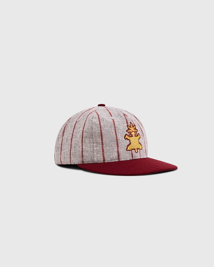 The Ebbets Field Mystery Caps of Mexico – Heroico Colegio Militar Authentic Wool Ballcap features gray wool with red stripes, a burgundy brim, and a yellow embroidered front graphic, displayed at an angle on a light gray background.