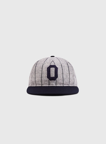 The Ebbets Field Osaka Tigers 1945 Authentic Wool Ballcap features gray wool with thin dark pinstripes, a black brim, and a bold navy 