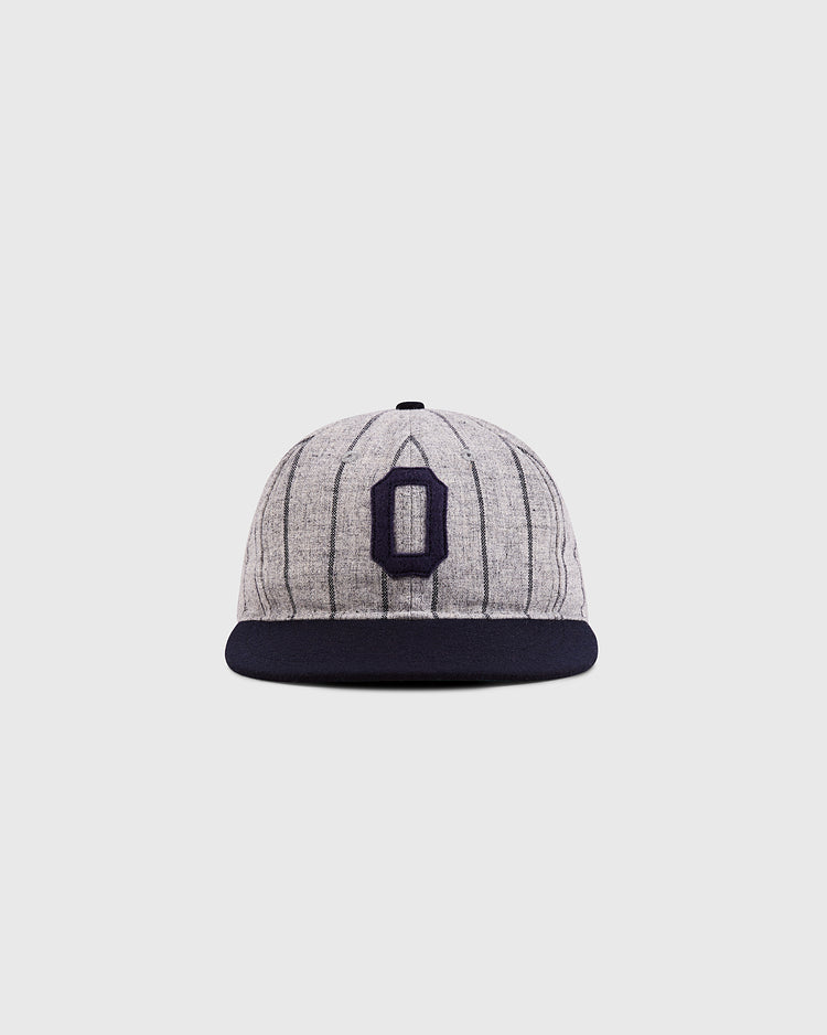 The Ebbets Field Osaka Tigers 1945 Authentic Wool Ballcap features gray wool with thin dark pinstripes, a black brim, and a bold navy 