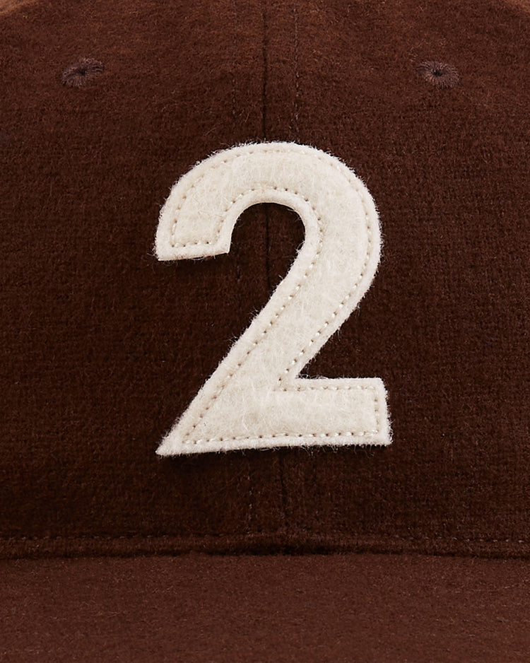 The Mystery Caps of Mexico – Transito 1930 Authentic Wool Ballcap by Ebbets Field is a brown wool cap featuring a bold white “2” on the front, inspired by Mexican baseball history—a unique collector’s item.