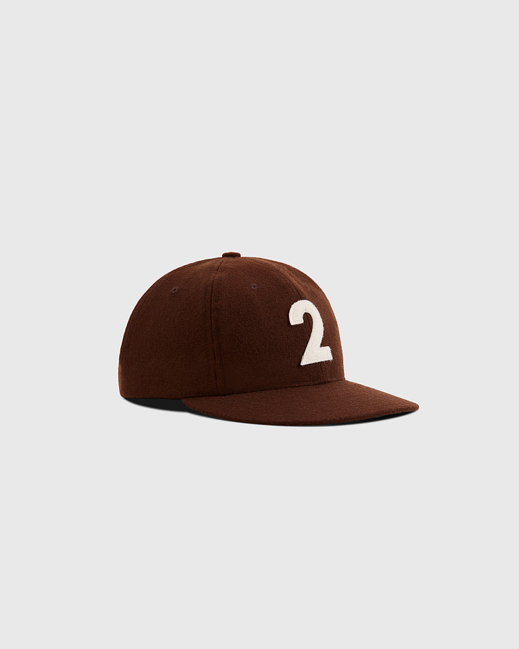 The Mystery Caps of Mexico – Transito 1930 Authentic Wool Ballcap by Ebbets Field features a brown design with a white number 2 on the front, shown against a light gray background—a must-have for fans of Mexican baseball heritage.