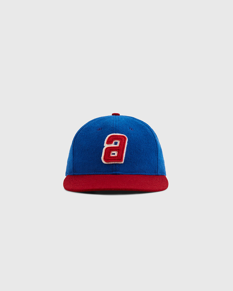 The Ebbets Field Sankei Atoms 1966 Vintage Inspired Wool Ballcap features a blue body, red brim, and white and red number 9 on the front—ideal for Astro Boy fans. Shown against a plain light gray background.